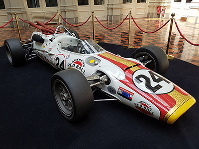 The replica #24 Lola T90 on display at the Hop Exchange in London in May 2019. Licenced by Flickr user 'Sarflondondunc' under Creative Commons licence Attribution-NonCommercial-NoDerivs 2.0 Generic. Original image has been cropped. The replica #24 Lola T90 on display at the Hop Exchange in London in May 2019. Licenced by Flickr user 'Sarflondondunc' under Creative Commons licence Attribution-NonCommercial-NoDerivs 2.0 Generic. Original image has been cropped.